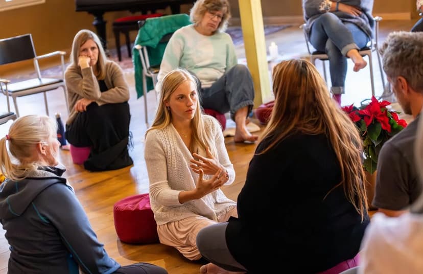 Ausbildungsgruppe sitzt am Boden im Kreis bei einer Prozessarbeit